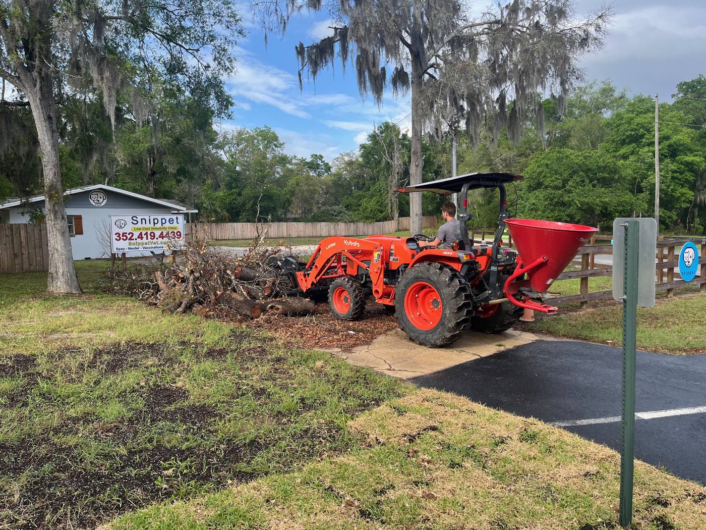 Tractor spreading seed at a commercial property